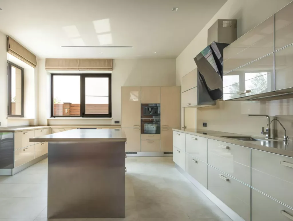 A modern kitchen featuring a large island and sleek stainless steel appliances.