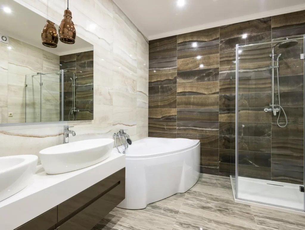 A modern bathroom featuring two sinks and a spacious shower area, designed with sleek fixtures and neutral tones.